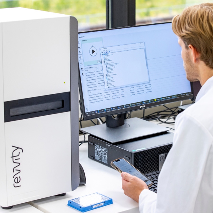 Eonis Q newborn screening system shown with monitor on a laboratory bench.