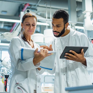 Researchers working together on quality assurance in a clinical lab setting
